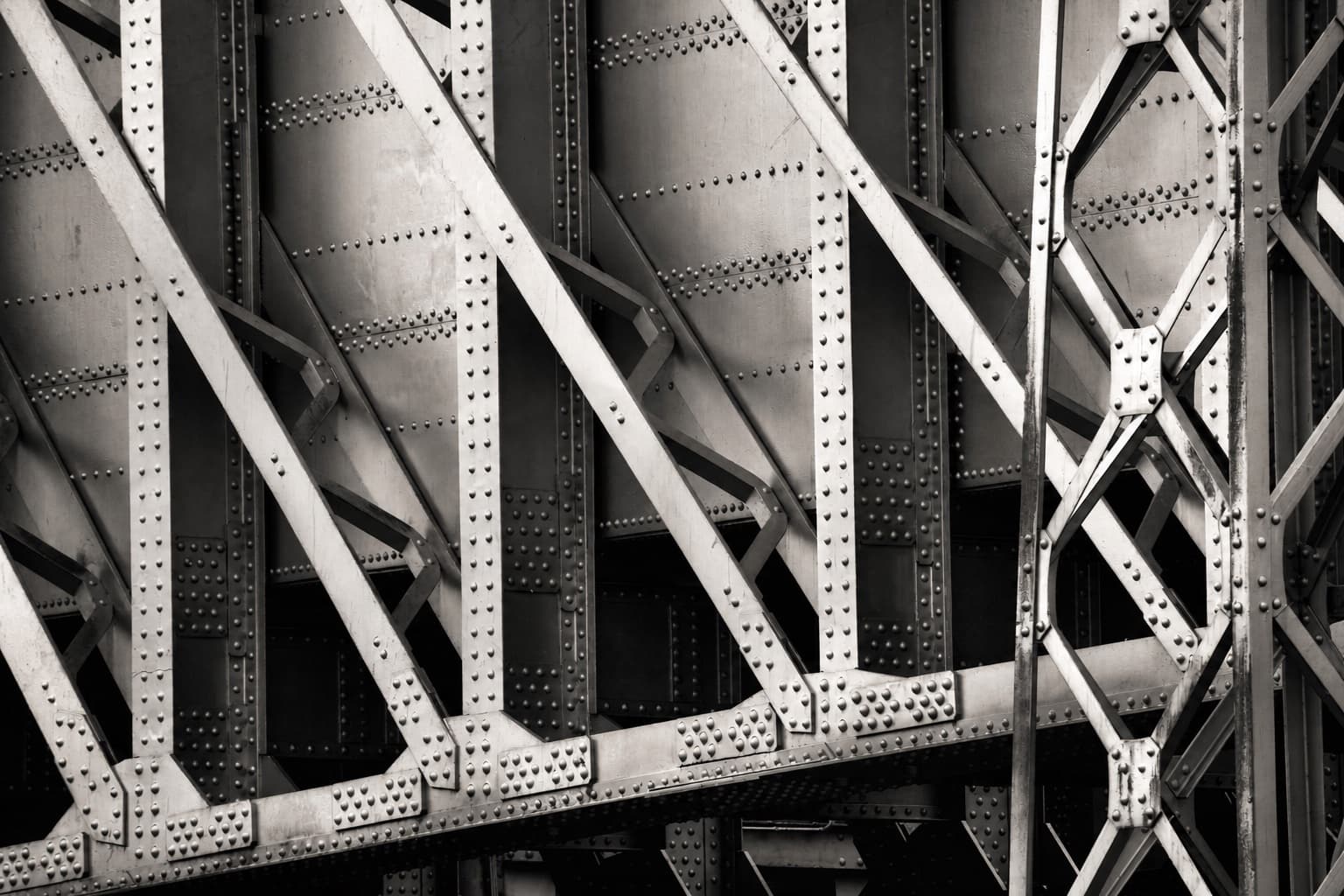 Interlocking riveted steel beams and structural supports
